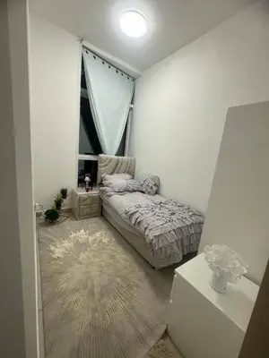 a small bedroom with a bed and a window at Pinnacle marina in Dubai