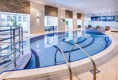 a large swimming pool in a hotel lobby at Pinnacle marina in Dubai