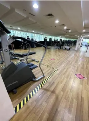 a gym with exercise equipment and a wooden floor at Pinnacle marina in Dubai