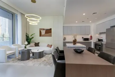 a kitchen and living room with a table and chairs at 313 Downtown Luxury Living at it's Finest in Dubai