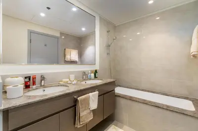 a bathroom with two sinks and a large mirror at 313 Downtown Luxury Living at it's Finest in Dubai