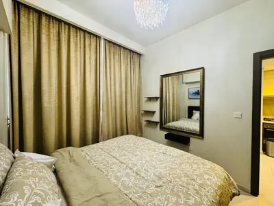 a bedroom with a bed and a mirror at Burj Khalifa Skyline View in Dubai