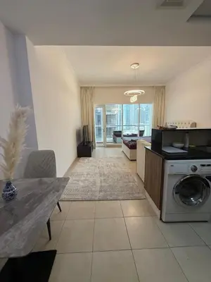 a living room with a washing machine and a table at Luxury 1BR studio with Scenic view near Dubai mall in Dubai