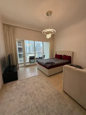 a bedroom with a bed and a large window at Luxury 1BR studio with Scenic view near Dubai mall in Dubai