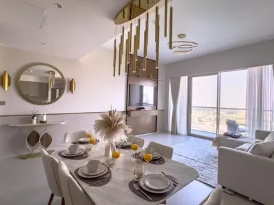 a dining room with a table and a living room at GRANDE SIGNATURE with a direct Burj Khalifa view and Private Fountain Show at high floor with DXB AIRPORT VIP Shuttle option for 6 guests in Dubai