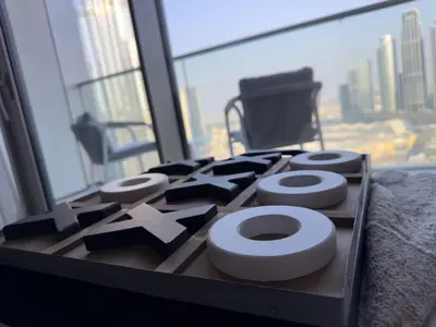 a table with a toilet in a room with a window at GRANDE SIGNATURE with a direct Burj Khalifa view and Private Fountain Show at high floor with DXB AIRPORT VIP Shuttle option for 6 guests in Dubai