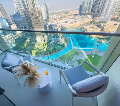 a balcony with two chairs and a view of a city at GRANDE SIGNATURE with a direct Burj Khalifa view and Private Fountain Show at high floor with DXB AIRPORT VIP Shuttle option for 6 guests in Dubai