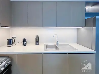 a kitchen with a sink and blue cabinets at Burj Crown Luxury 2BR I Balcony & Panoramic Views in Dubai