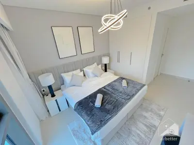 an overhead view of a bedroom with a bed and a chandelier at Burj Crown Luxury 2BR I Balcony & Panoramic Views in Dubai