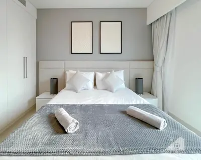 a bedroom with a bed with two towels on it at Burj Crown Luxury 2BR I Balcony & Panoramic Views in Dubai