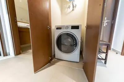 a washer and dryer in a laundry room at FAM Living - 3BR Creekside Escape in Creek Rise Tower 2 in Dubai