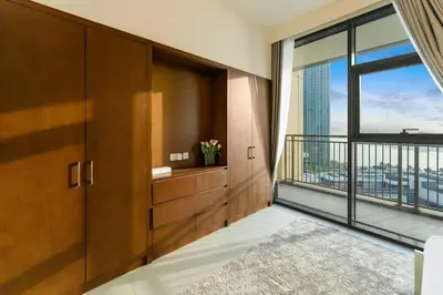 a large room with a large window and a balcony at FAM Living - 3BR Creekside Escape in Creek Rise Tower 2 in Dubai