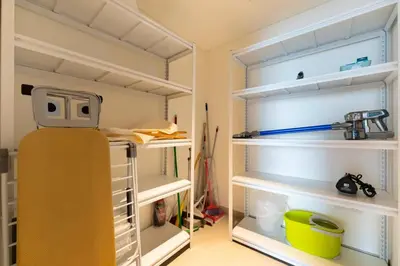a room with an empty closet with a refrigerator at FAM Living - 3BR Creekside Escape in Creek Rise Tower 2 in Dubai