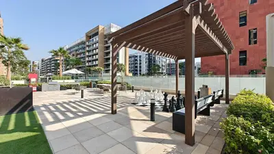 a pavilion with chessetts on it next to a building at Chic and comfortable Studio Near Downtown and Canal in Dubai