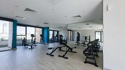 a gym with treadmills and machines in a building at Chic and comfortable Studio Near Downtown and Canal in Dubai