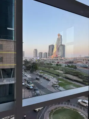 a view of a city from a window in a building at Elegant Master bedroom with view in Dubai