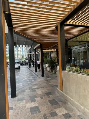 a building with awning over a sidewalk with a street at Elegant Master bedroom with view in Dubai