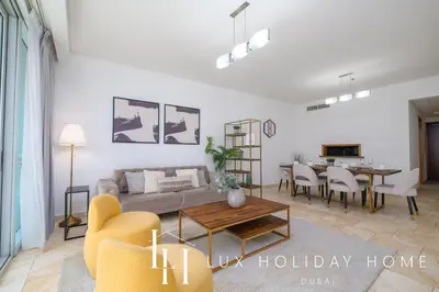 a living room with a couch and a table at LUX The Luxury Sunny JBR Beach Views 2 in Dubai