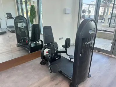 a gym with a row of exercise equipment in a room at Cosy studio Free Parking Free unlimited drinkable water Near Downtown in Dubai