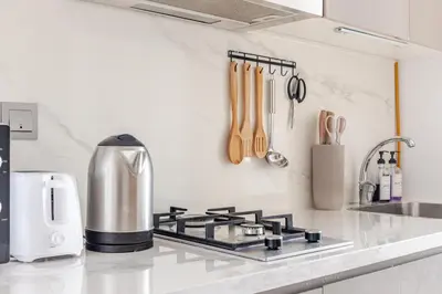 a kitchen counter top with a stove top oven at Cosy studio Free Parking Free unlimited drinkable water Near Downtown in Dubai
