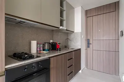 a kitchen with a stove and a counter top at Chic Studio in Arjan with Gym Pool Free parking in Dubai