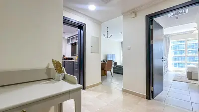 a hallway with a door leading to a living room at Relaxing Marina View Stay, Walk to Beach & Mall - 27AB02 in Dubai