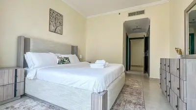 a bedroom with a large white bed and a mirror at Relaxing Marina View Stay, Walk to Beach & Mall - 27AB02 in Dubai