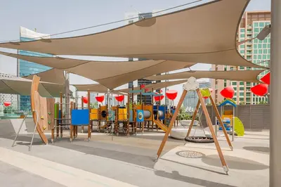 a playground with awning over a play area at Luxury Studio mints Walk to Dubai Mall & Burj Khalifa in Dubai
