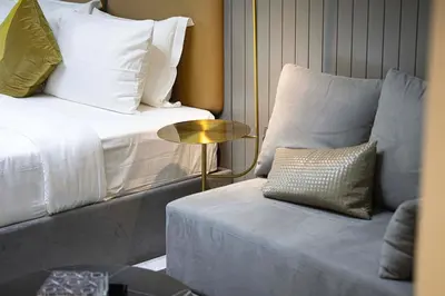 a room with a bed and a couch and a table at Luxury Studio mints Walk to Dubai Mall & Burj Khalifa in Dubai
