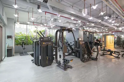 a gym with several tread machines and a man working out at Luxury Studio mints Walk to Dubai Mall & Burj Khalifa in Dubai