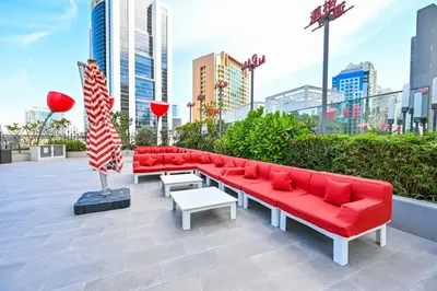 a group of red couches and a pole in a city at Luxury Studio mints Walk to Dubai Mall & Burj Khalifa in Dubai