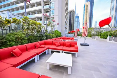 a red couch sitting on top of a building at Luxury Studio mints Walk to Dubai Mall & Burj Khalifa in Dubai