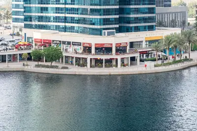 a building next to a body of water at Urban Studio Apartment in Goldcrest Views JLT in Dubai