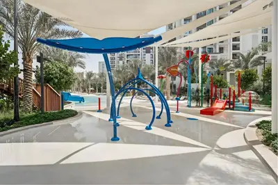 a playground at a resort with a blue swing at Premium Home in Creek Beach with Lagoon Access in Dubai
