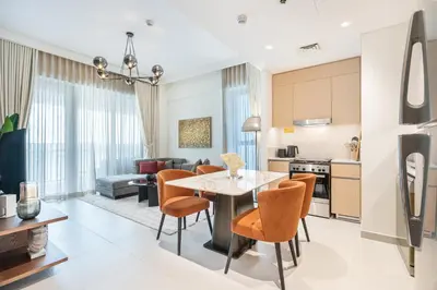 a kitchen and living room with a table and chairs at Premium Home in Creek Beach with Lagoon Access in Dubai