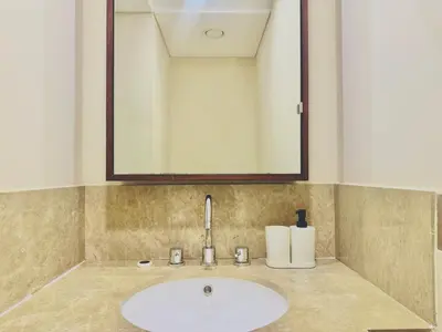 a bathroom with a sink and a mirror at Venduras- Chic 1BR Getaway near Burj Khalifa in Dubai