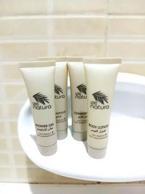 three tubes of sunscreen sitting on top of a sink at Chic 1BR Retreat with Lake Views & Modern Comforts in Dubai