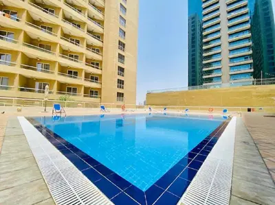 a large swimming pool in front of a building at Chic 1BR Retreat with Lake Views & Modern Comforts in Dubai