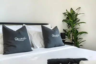 a bed with two pillows on top of it at Chic Marina Arcade Apartment Minutes to Beach in Dubai