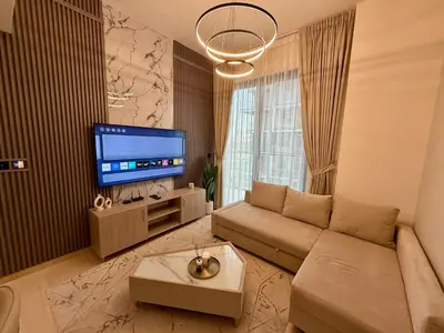 a living room with a couch and a flat screen tv at Smart & Stylish 1BHK With Keyless Entry! in Dubai