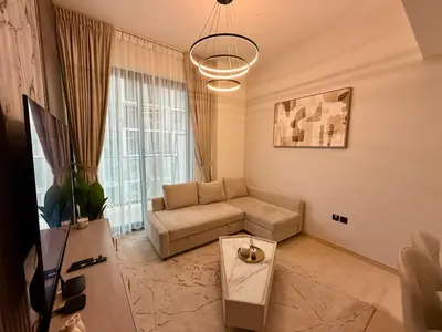 a living room with a couch and a table at Smart & Stylish 1BHK With Keyless Entry! in Dubai