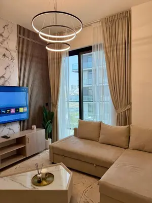 a living room with a couch and a tv at Smart & Stylish 1BHK With Keyless Entry! in Dubai