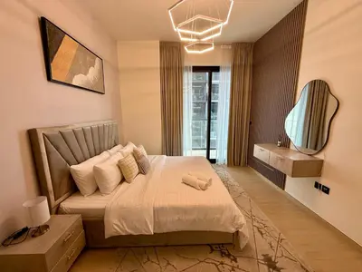 a bedroom with a large bed with a window at Smart & Stylish 1BHK With Keyless Entry! in Dubai