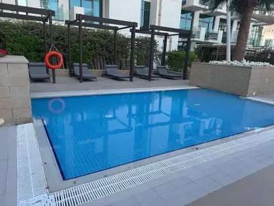 a swimming pool with an orange object in a building at Cozy studio Pet Friendly Pool, Gym, Water Near Downtown in Dubai