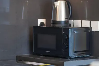 a microwave with a coffee pot on top of it at Mahogany 11 - 2BR 10 Guests - Walk to Burj Khalif in Dubai