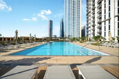 a swimming pool in the middle of a city with buildings at Mahogany 11 - 2BR 10 Guests - Walk to Burj Khalif in Dubai