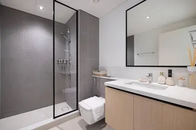 a bathroom with a shower and a sink and a toilet at Mahogany 12 - 2BR 10 Guests - Walk to Burj Khalifa in Dubai