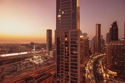 a city skyline with a tall skyscraper at Mahogany 12 - 2BR 10 Guests - Walk to Burj Khalifa in Dubai