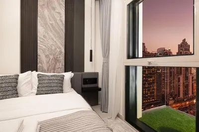 a bedroom with a window with a view of a city at Mahogany 12 - 2BR 10 Guests - Walk to Burj Khalifa in Dubai