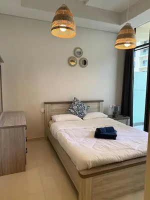 a bedroom with a large bed with two lights at Samani vacation homes 4906 canal view in Dubai